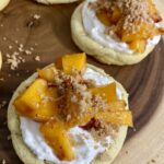 Picture of Peaches and Cream Crumble top cookies sitting on a wood board.